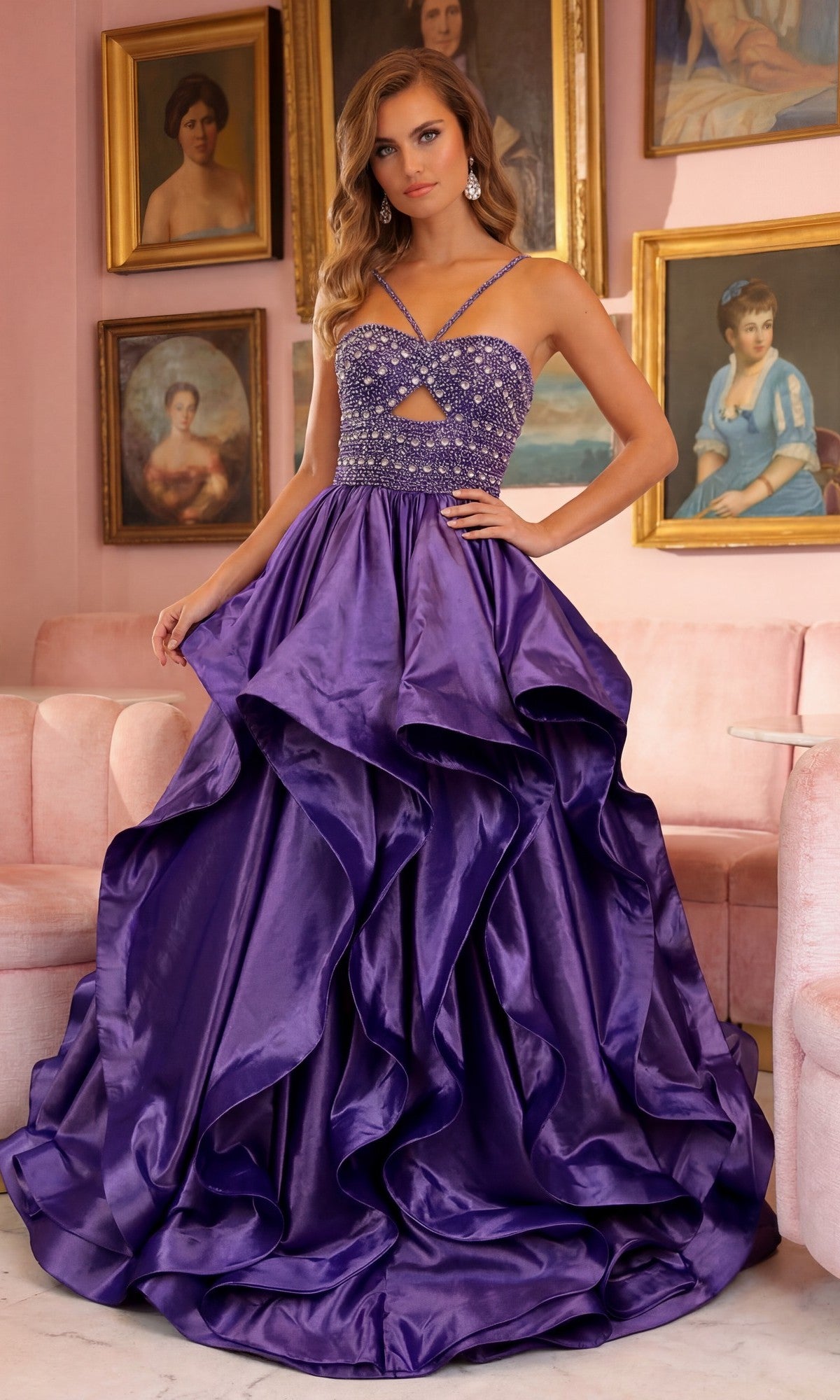 A woman in a lilac Ava Presley 40054 Horsehair-Hem Prom Ball Gown with a beaded bodice stands in a pink room decorated with framed portraits and pastel furniture.